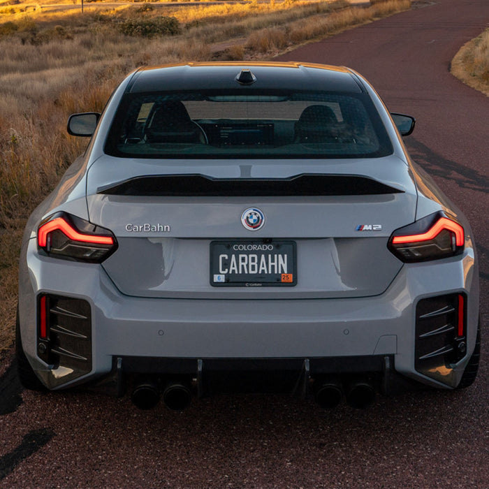 BMW car with 'CarBahn' license plate on a road