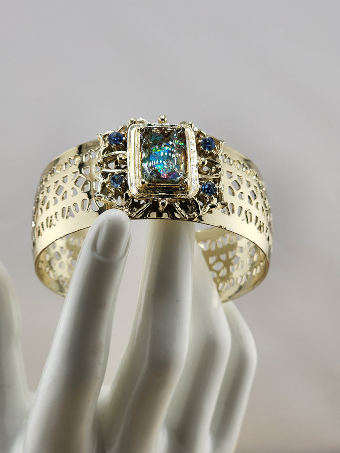 Gold Tone Cuff Bracelet with Multicolor Center Stone and Blue Accent Gems 0543